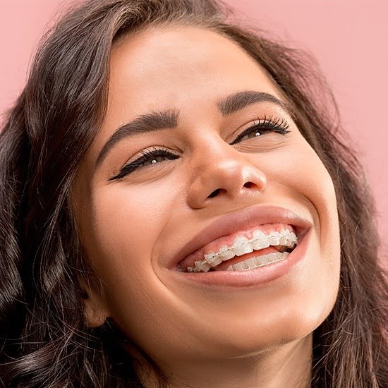 A patient smiling with braces at Dante Gonzales Orthodontics